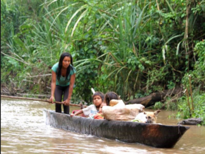 Indigenous family traveling by canoe on the Bobonaza River in the Ecuadorian Amazon (Credit: The Ecologist)